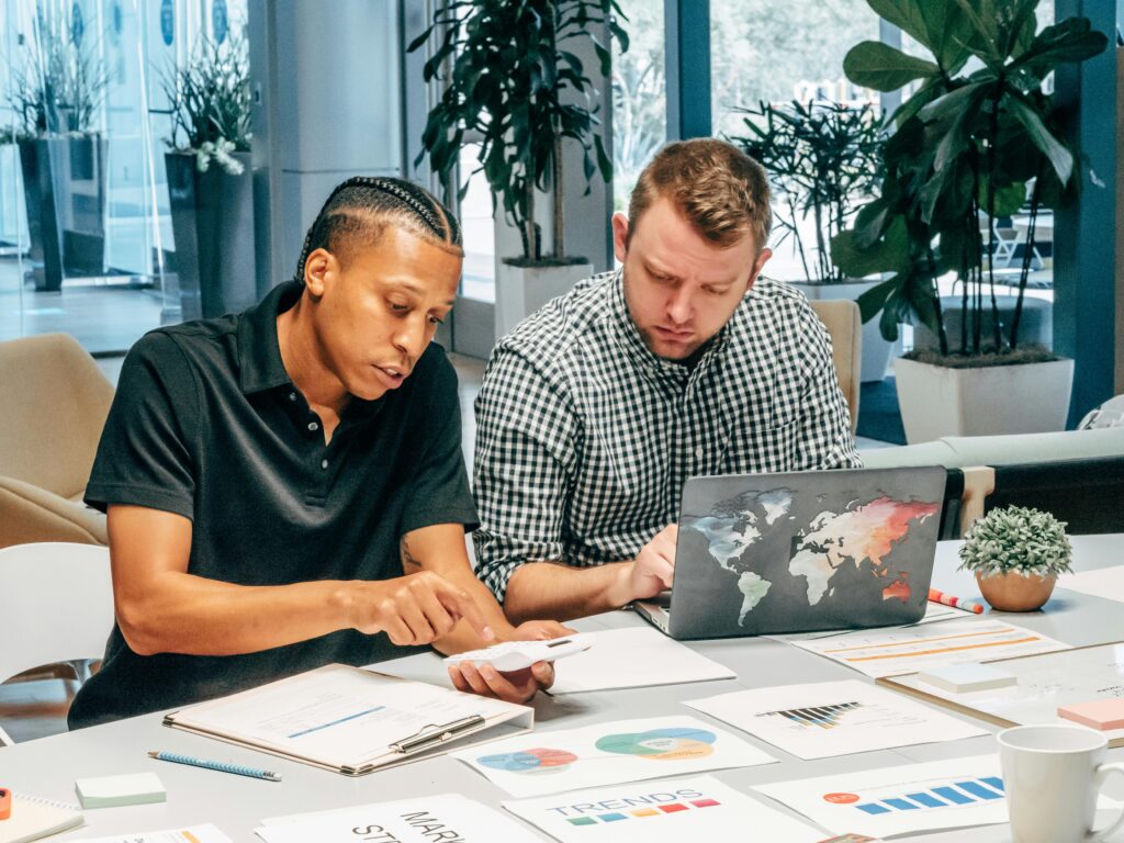 Leadership teams reviewing performance data as organizational alignment becomes harder to maintain during growth